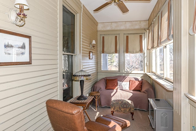 sunroom / solarium featuring ceiling fan