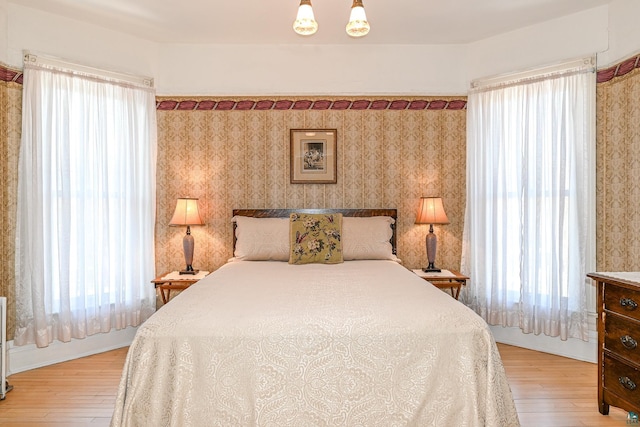 bedroom featuring light wood-style flooring and multiple windows