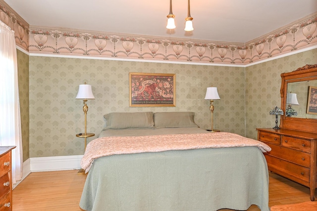 bedroom featuring light wood-style flooring and baseboards