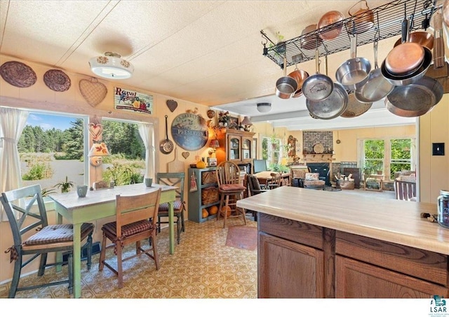 7262 Palo Tia Rd, Embarrass, MN 55732 - kitchen featuring a textured ceiling, light countertops, and brown cabinets