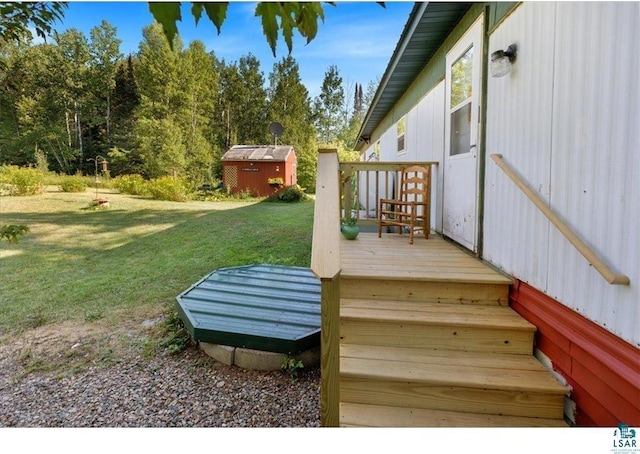 7262 Palo Tia Rd, Embarrass, MN 55732 - wooden terrace with a shed, a lawn, and an outdoor structure