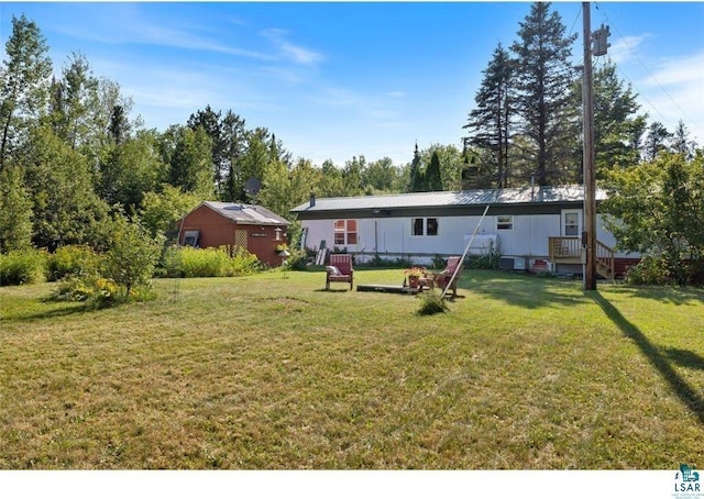 7262 Palo Tia Rd, Embarrass, MN 55732 - back of property with a lawn and view of wooded area
