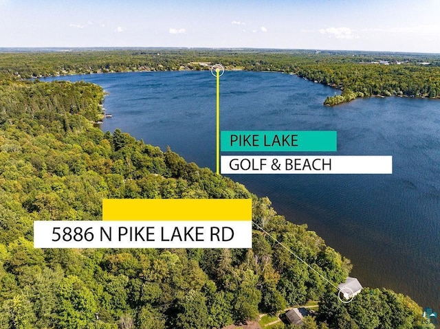 aerial view of a heavily wooded area and a nearby body of water