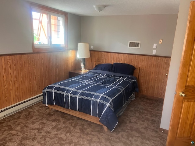 5346 Lester River Rd, Duluth, MN 55804 - carpeted bedroom featuring wainscoting, wood walls, and a baseboard heating unit