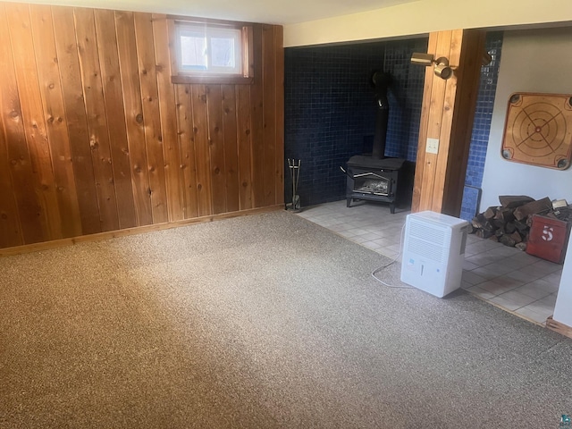 5346 Lester River Rd, Duluth, MN 55804 - unfurnished living room featuring wooden walls, a wood stove, and carpet