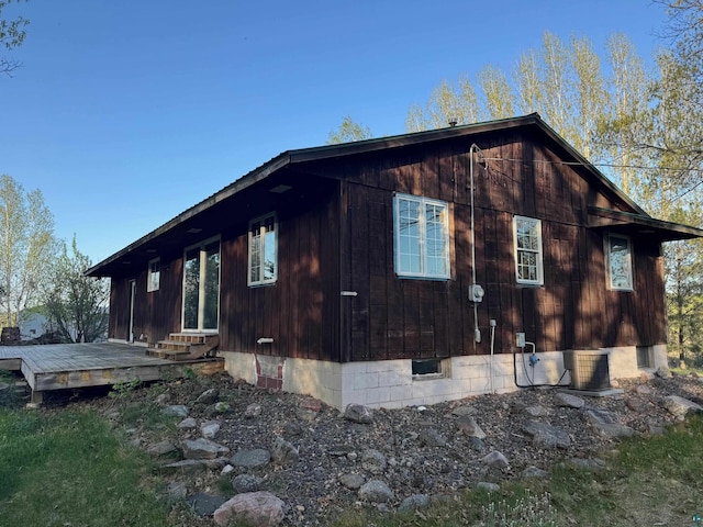 view of home's exterior featuring a deck and entry steps