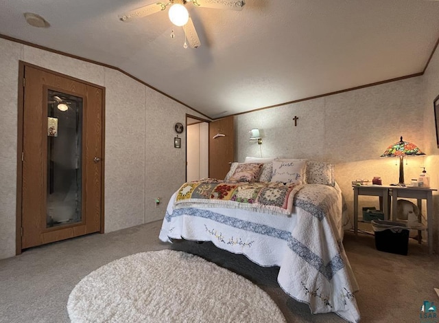 carpeted bedroom featuring crown molding, lofted ceiling, and a ceiling fan