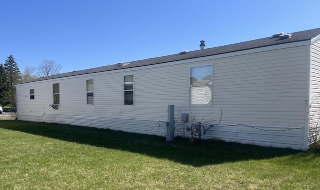 view of side of property with a yard