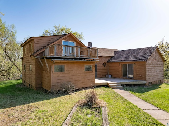 77 Solway Rd, Esko, MN 55733 - rear view of property with roof with shingles, a balcony, a wooden deck, and a lawn