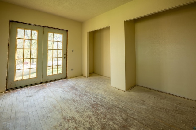 77 Solway Rd, Esko, MN 55733 - unfurnished room with french doors and a textured ceiling