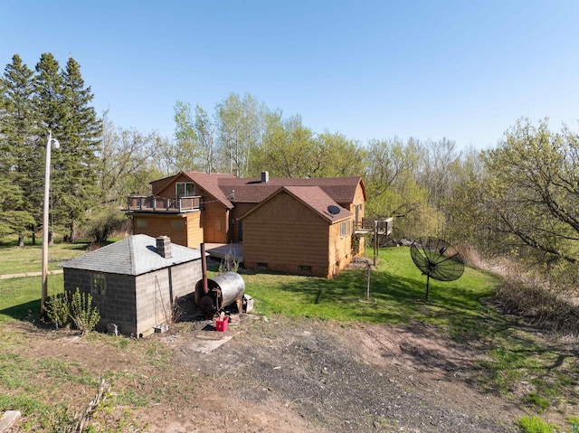 77 Solway Rd, Esko, MN 55733 - view of side of home featuring crawl space, a balcony, a yard, and dirt driveway