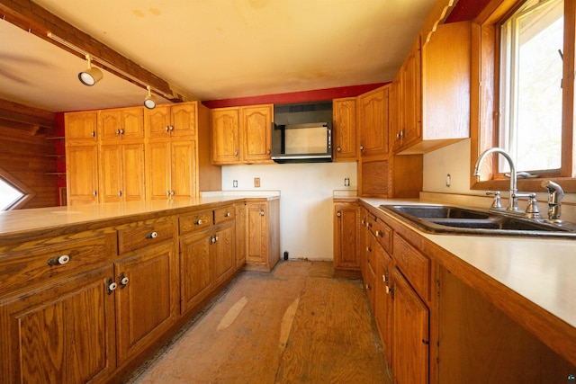 77 Solway Rd, Esko, MN 55733 - kitchen with a sink, brown cabinetry, track lighting, and light countertops