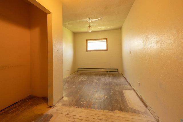 77 Solway Rd, Esko, MN 55733 - empty room with baseboard heating and wood-type flooring