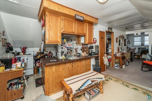 304 Carlton Ave, Cloquet, MN 55720 - kitchen with dark countertops, brown cabinets, and white range with electric cooktop