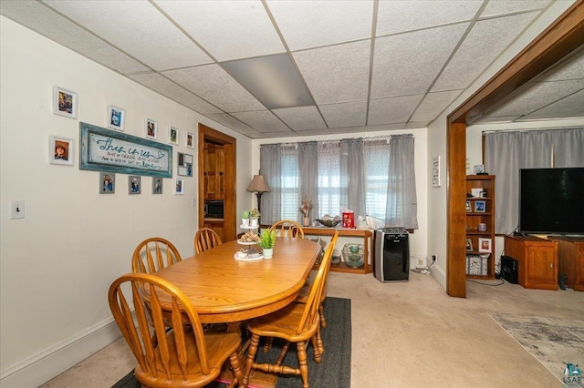 304 Carlton Ave, Cloquet, MN 55720 - dining space featuring baseboards, a drop ceiling, and carpet floors