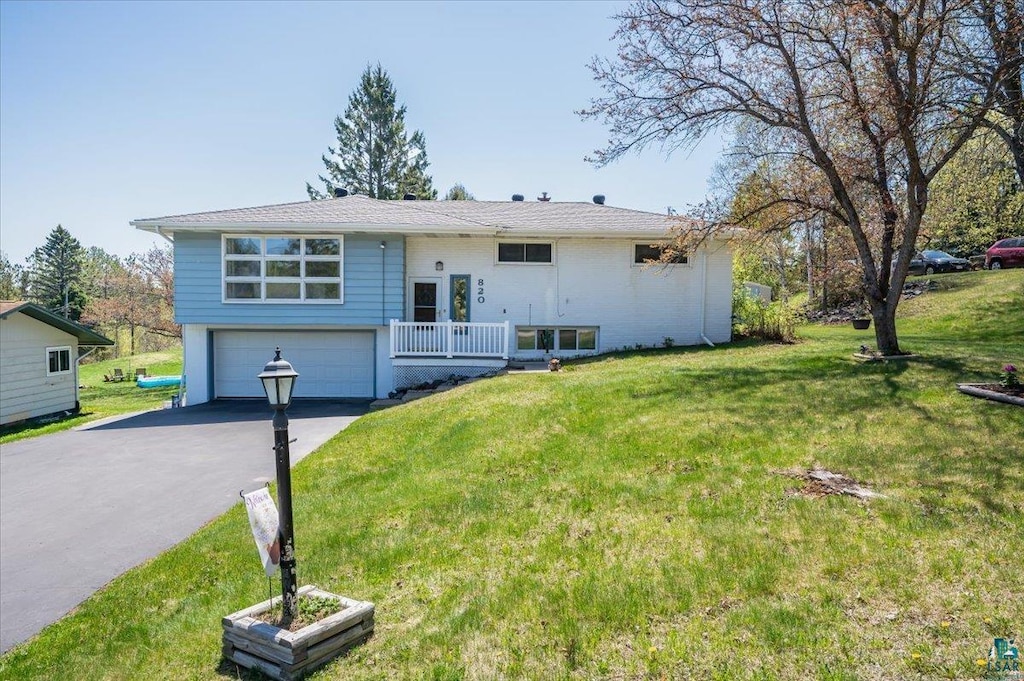 820 Claymore St, Duluth, MN 55803 - bi-level home featuring an attached garage, driveway, and a front lawn