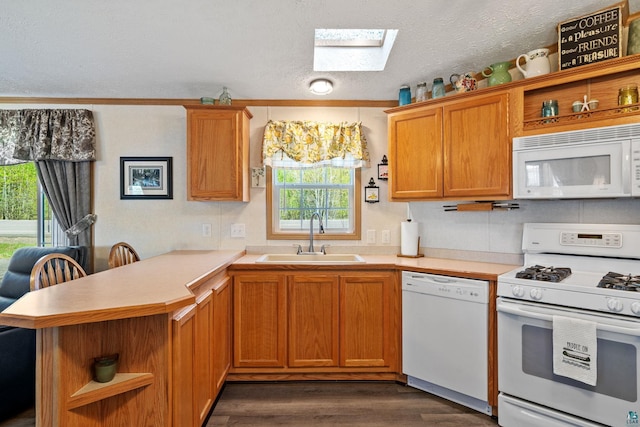10412 Lakeside Dr, Finlayson, MN 55735 - kitchen featuring white appliances, a sink, open shelves, a skylight, and a peninsula
