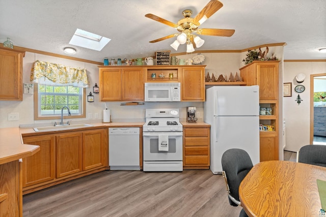 10412 Lakeside Dr, Finlayson, MN 55735 - kitchen featuring white appliances, a sink, a skylight, light countertops, and a textured ceiling
