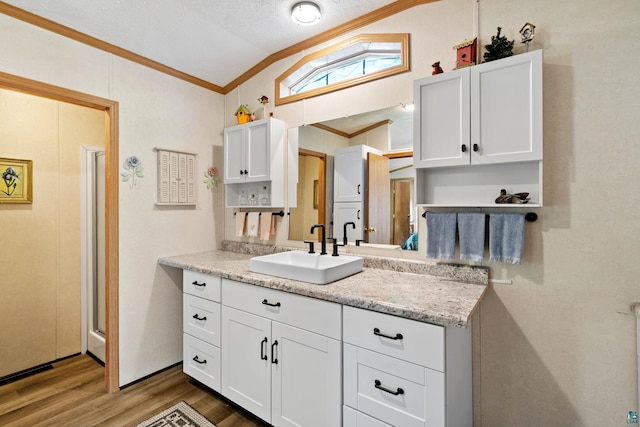 10412 Lakeside Dr, Finlayson, MN 55735 - kitchen with lofted ceiling, crown molding, a sink, wood finished floors, and white cabinets