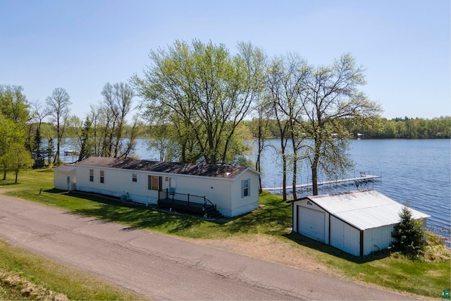 10412 Lakeside Dr, Finlayson, MN 55735 - view of front of house featuring a water view, a garage, an outbuilding, and a front yard
