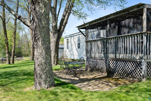 10412 Lakeside Dr, Finlayson, MN 55735 - view of green lawn featuring a deck and a patio area