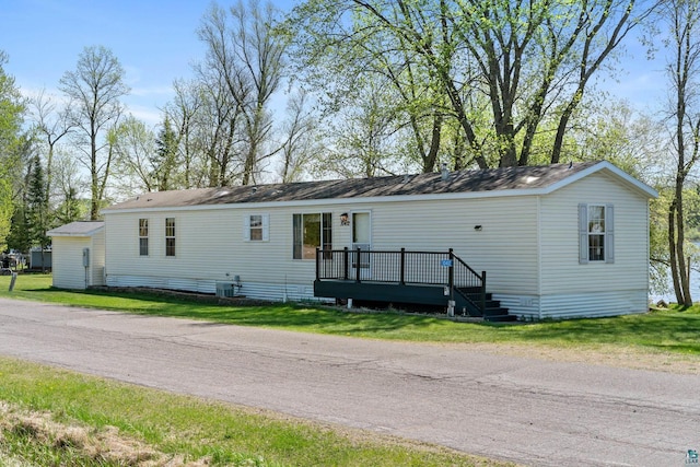 10412 Lakeside Dr, Finlayson, MN 55735 - manufactured / mobile home with a wooden deck, central AC unit, and a front yard