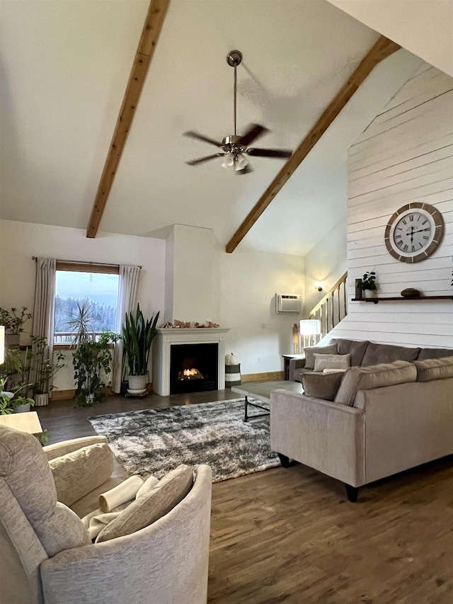 7789 Jokela Rd, Cloquet, MN 55720 - living area with high vaulted ceiling, beam ceiling, ceiling fan, wood finished floors, and a lit fireplace