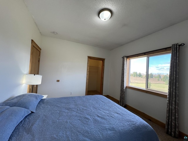 7789 Jokela Rd, Cloquet, MN 55720 - carpeted bedroom featuring baseboards and a textured ceiling