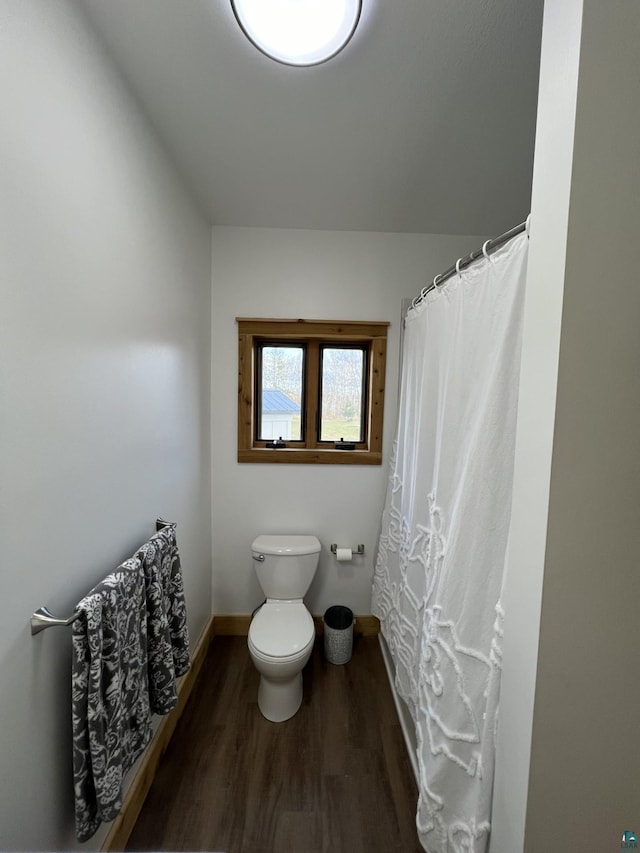 7789 Jokela Rd, Cloquet, MN 55720 - full bath with wood finished floors, toilet, and baseboards
