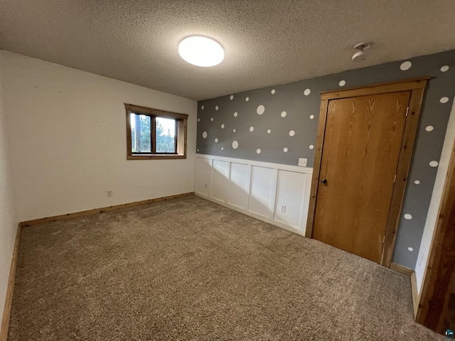 7789 Jokela Rd, Cloquet, MN 55720 - spare room with a textured ceiling and carpet flooring