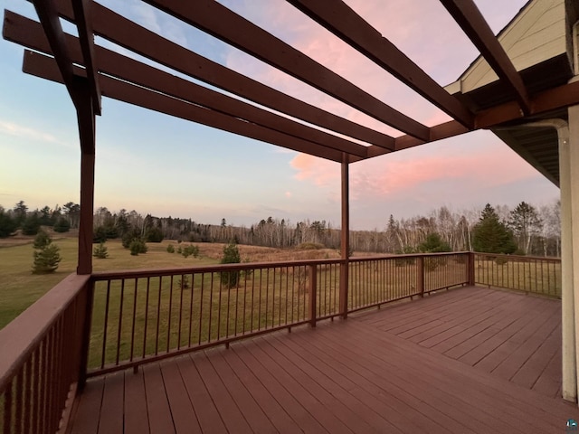 7789 Jokela Rd, Cloquet, MN 55720 - deck at dusk with a pergola, a yard, a rural view, and view of scattered trees
