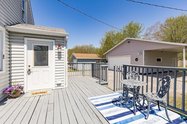 426 22nd St, Cloquet, MN 55720 - wooden terrace featuring an outdoor structure and a garage