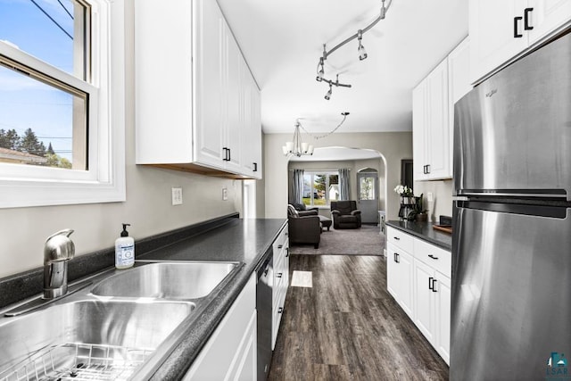 426 22nd St, Cloquet, MN 55720 - kitchen with freestanding refrigerator, dark countertops, a sink, dark wood-type flooring, and white cabinets
