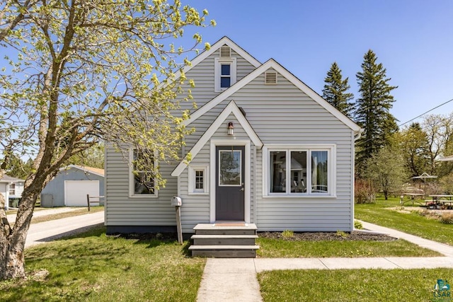 426 22nd St, Cloquet, MN 55720 - view of front of house featuring a front lawn and an outdoor structure