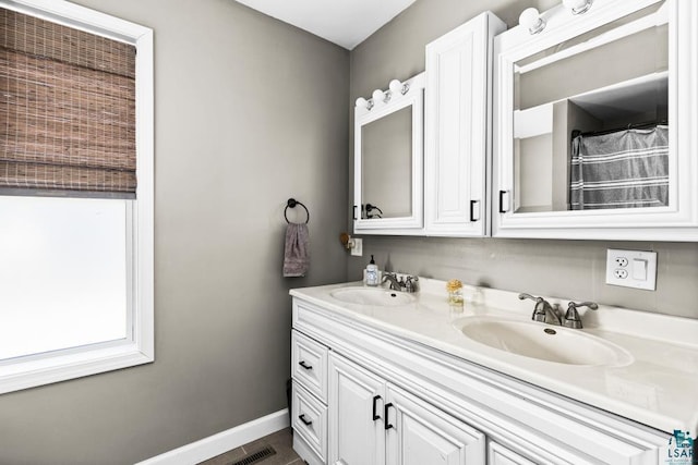 426 22nd St, Cloquet, MN 55720 - full bathroom with baseboards and double vanity