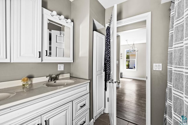 426 22nd St, Cloquet, MN 55720 - bathroom with a chandelier, vanity, and tile patterned flooring