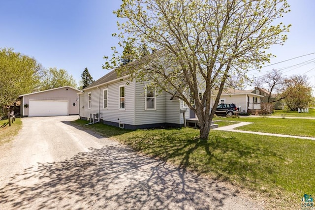426 22nd St, Cloquet, MN 55720 - view of front of property with an outbuilding, a garage, and a front yard