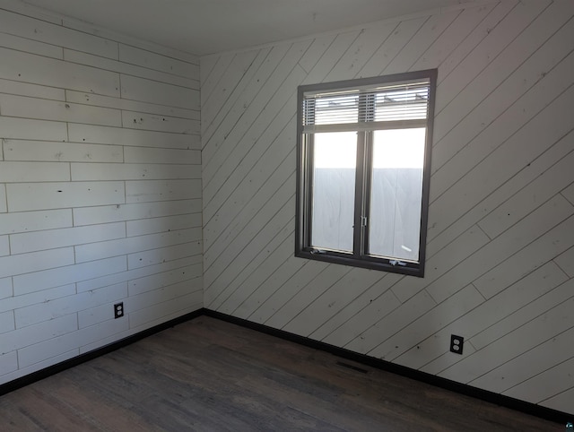 81 Edison Blvd, Silver Bay, MN 55614 - empty room with dark wood-style flooring and wood walls