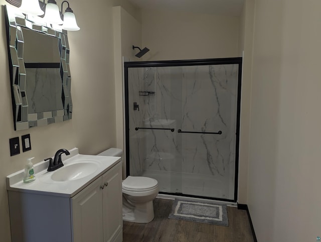 81 Edison Blvd, Silver Bay, MN 55614 - bathroom with a marble finish shower, wood finished floors, toilet, and vanity