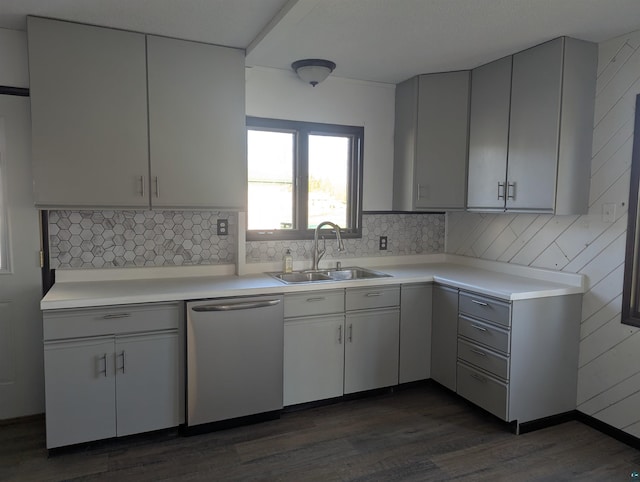 81 Edison Blvd, Silver Bay, MN 55614 - kitchen with stainless steel dishwasher, a sink, light countertops, dark wood-style floors, and backsplash