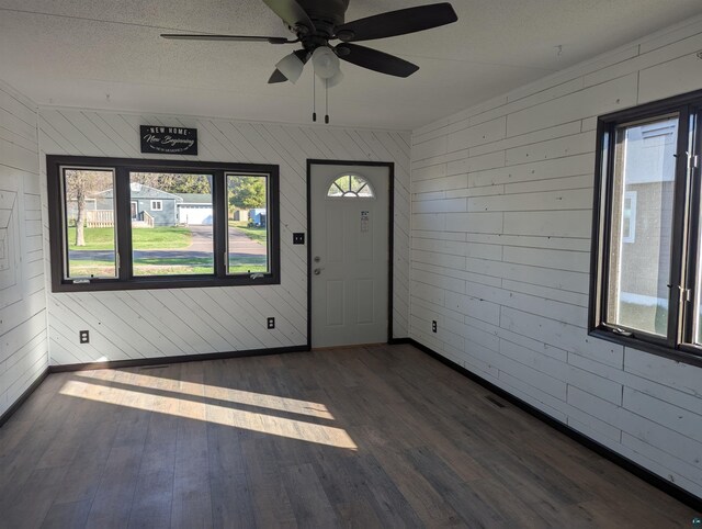81 Edison Blvd, Silver Bay, MN 55614 - foyer with wood finished floors, baseboards, ceiling fan, and wooden walls