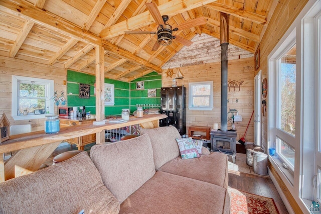 10173 Little Marais Trl, Silver Bay, MN 55614 - living room featuring wooden ceiling, wooden walls, a wood stove, hardwood / wood-style floors, and ceiling fan