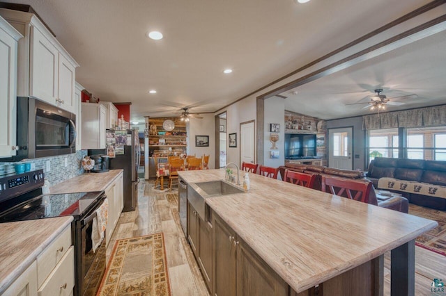 10173 Little Marais Trl, Silver Bay, MN 55614 - kitchen featuring stainless steel appliances, a ceiling fan, a sink, white cabinets, and recessed lighting