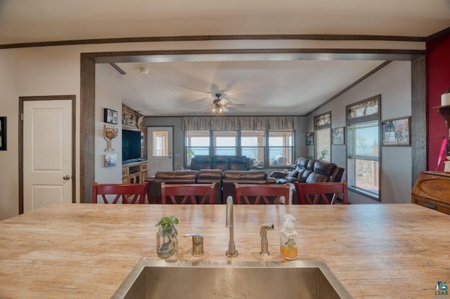 10173 Little Marais Trl, Silver Bay, MN 55614 - kitchen featuring a sink, a ceiling fan, vaulted ceiling, light countertops, and ornamental molding