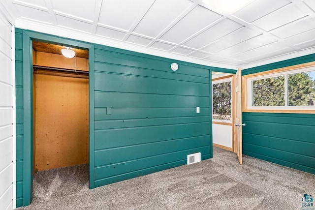 2106 Piedmont Ave, Duluth, MN 55811 - unfurnished bedroom featuring carpet flooring, a closet, and wood walls