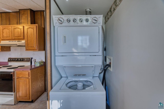 4538 Bass Lake Rd, Gilbert, MN 55741 - laundry area featuring stacked washer / drying machine and light tile patterned floors