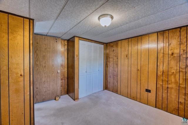 4538 Bass Lake Rd, Gilbert, MN 55741 - unfurnished bedroom with wood walls and carpet flooring