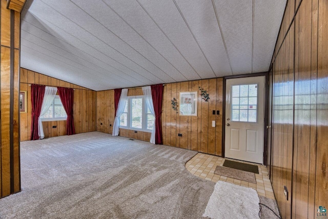 4538 Bass Lake Rd, Gilbert, MN 55741 - carpeted entrance foyer with healthy amount of natural light and wood walls