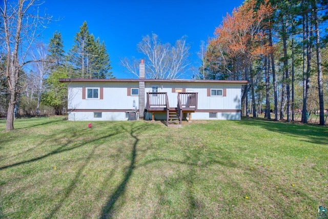 4538 Bass Lake Rd, Gilbert, MN 55741 - rear view of property featuring a wooden deck, a chimney, and a lawn