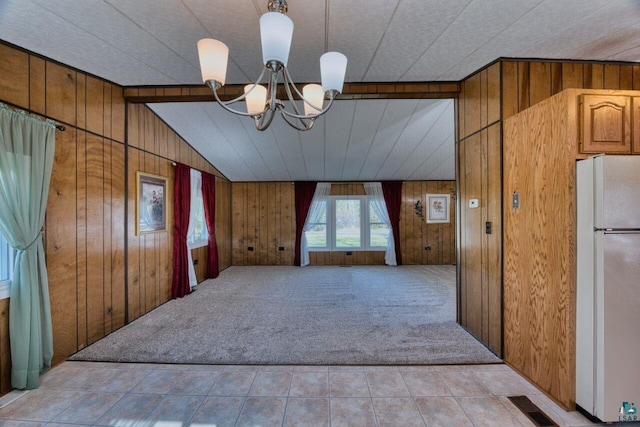 4538 Bass Lake Rd, Gilbert, MN 55741 - unfurnished dining area with wood walls, a chandelier, light colored carpet, and light tile patterned floors
